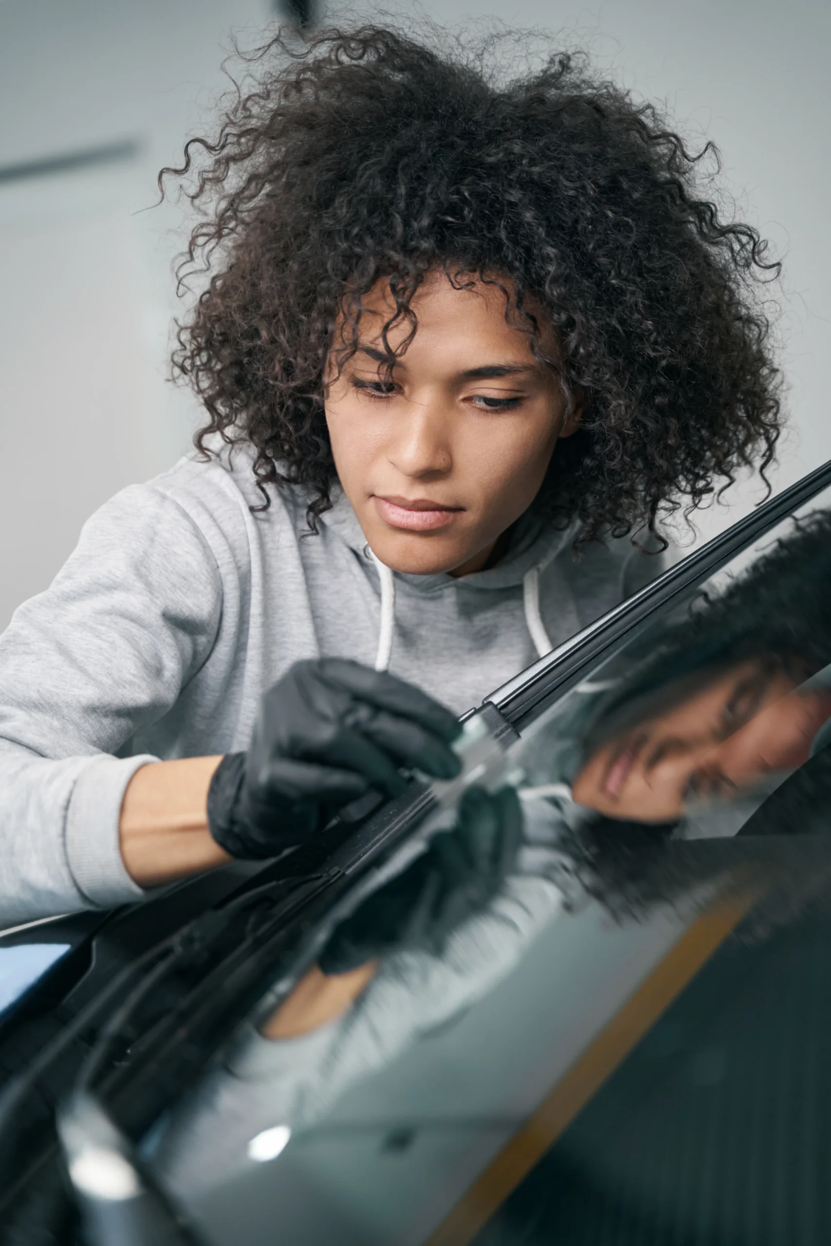 worker-removing-debris-from-windscreen-surface